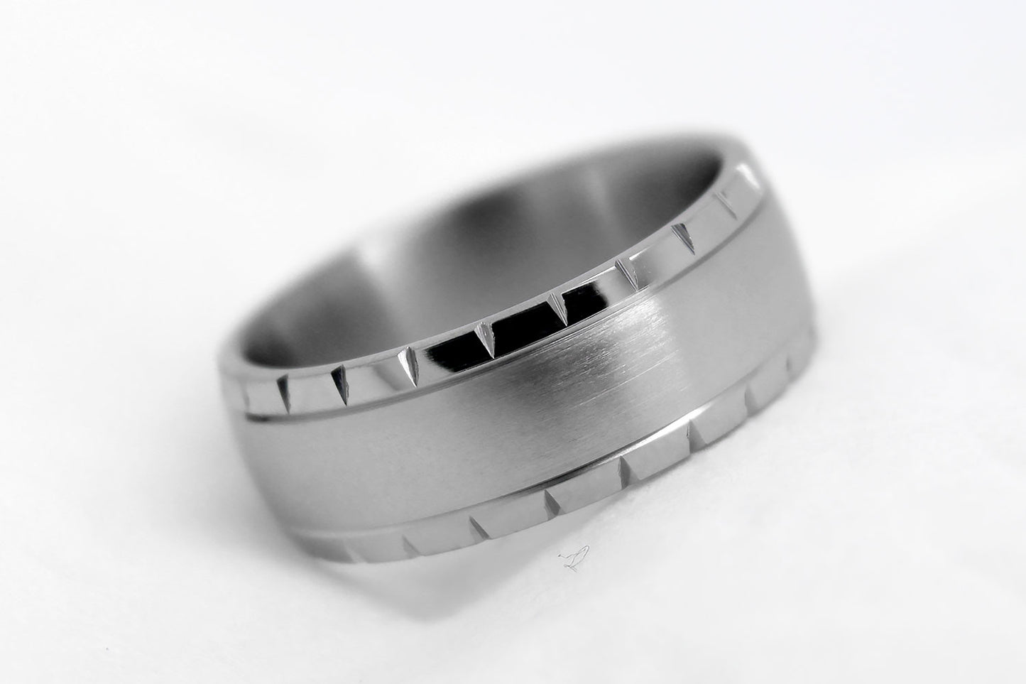 Matte Titanium ring with a textured band on a white background