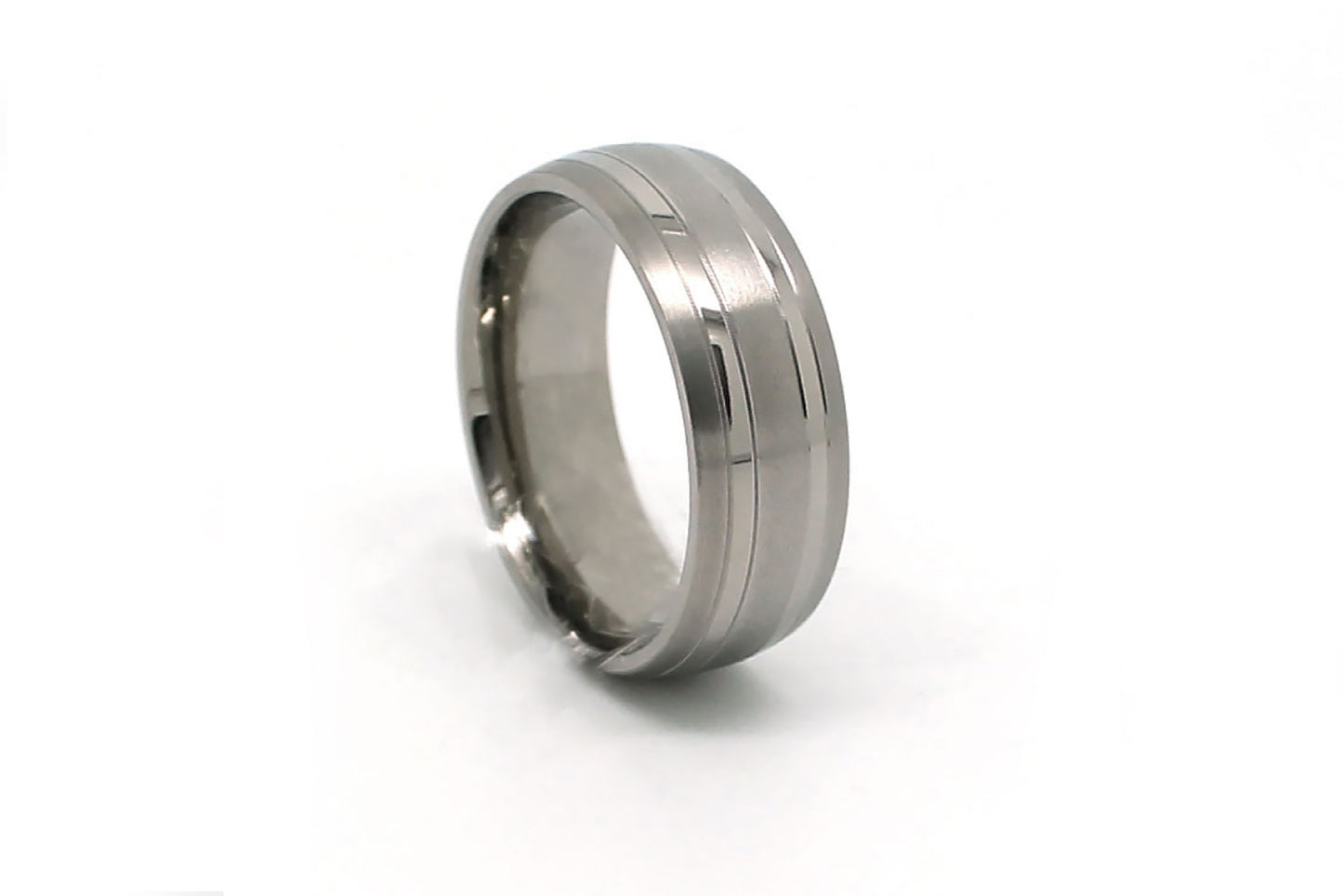 Titanium ring with a reflective surface on a white background