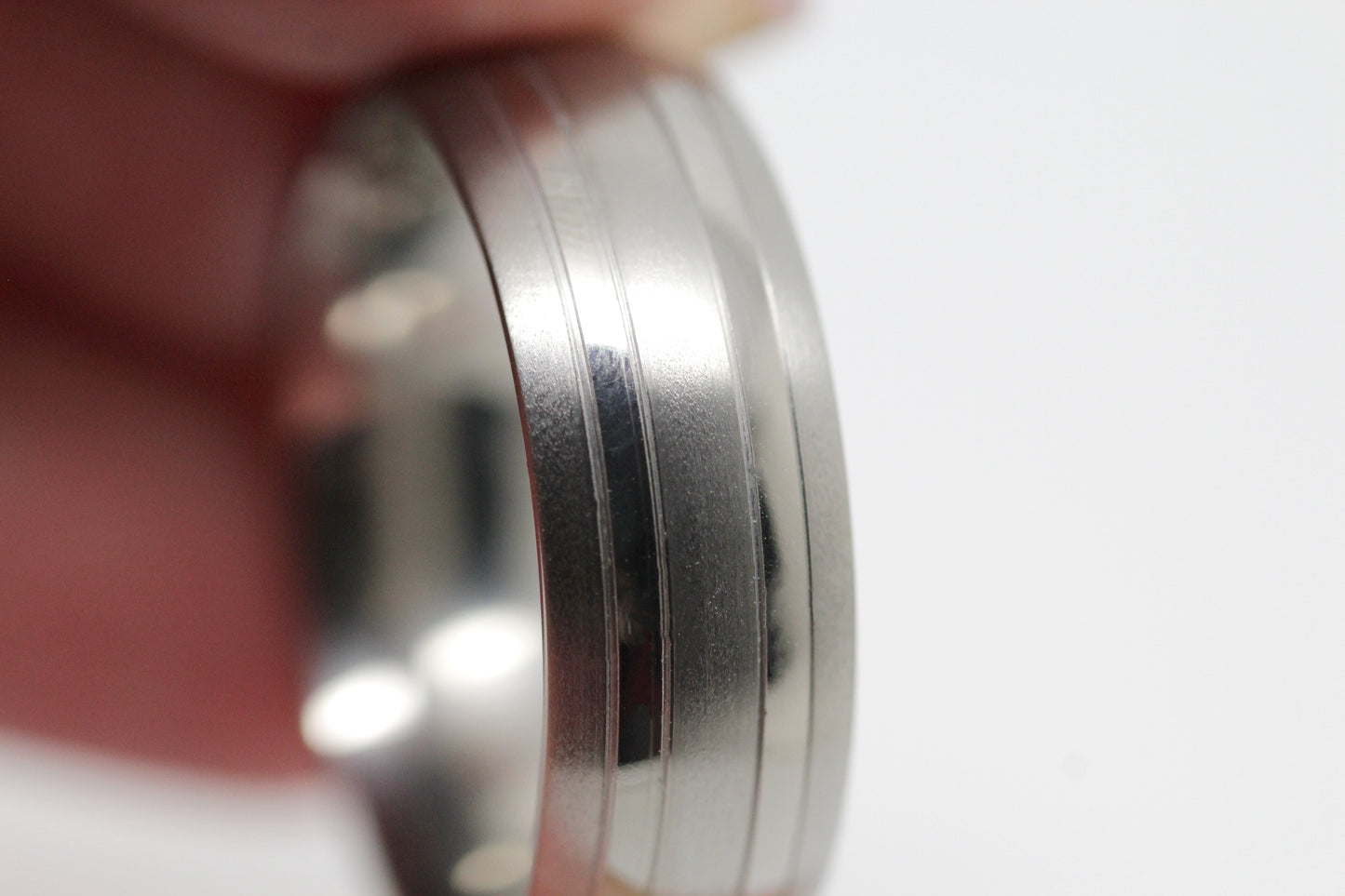 Close-up of a matte titanium wedding band with polished lines,perfect for men and women as a wedding or anniversary band.