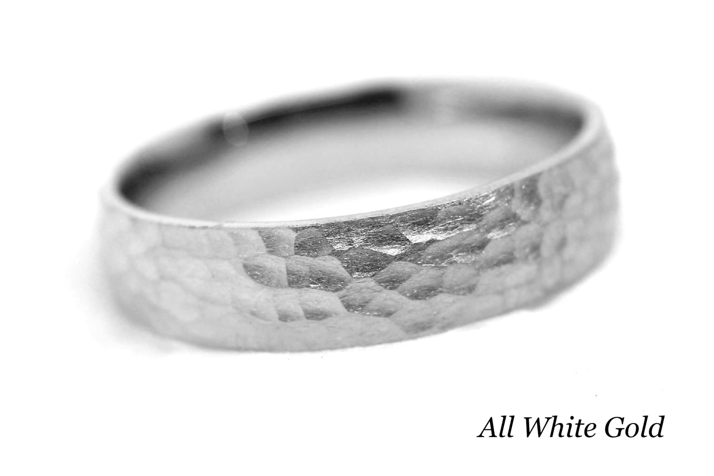 White gold ring with a hammered surface on a white background.