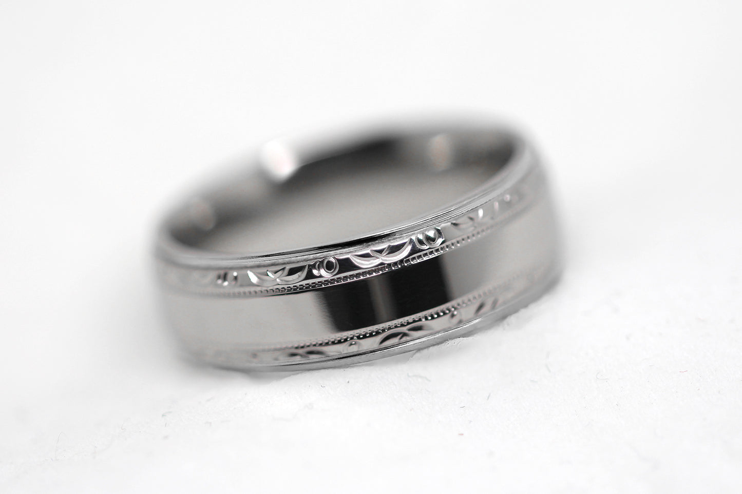 Polished 6mm titanium wedding ring for men and women with filigree edge, perfect for anniversaries and engagements.