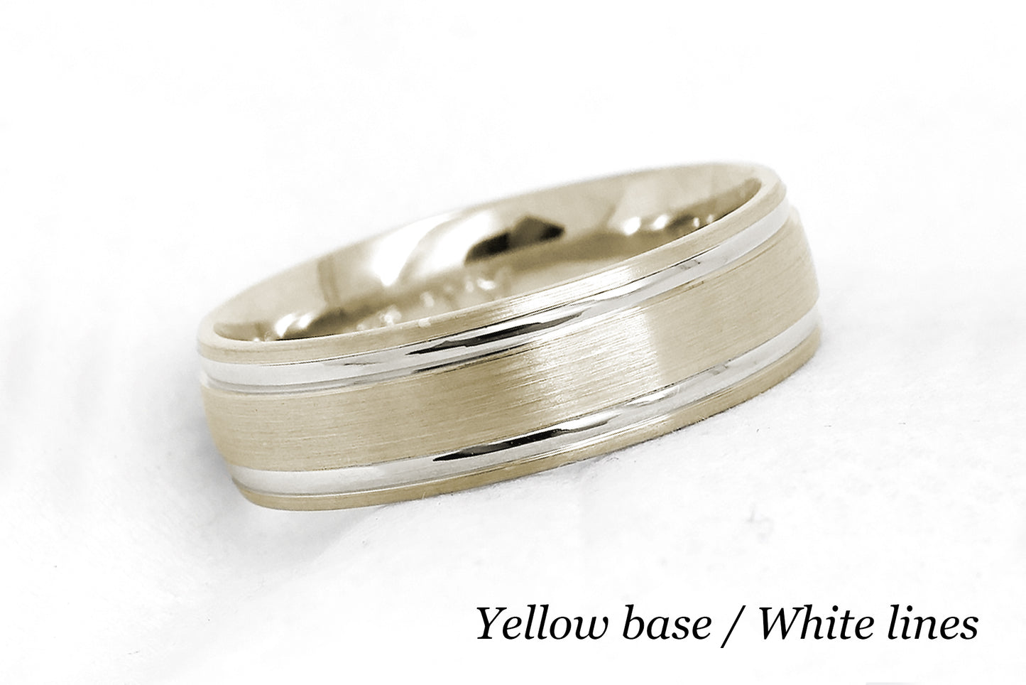 solid gold wedding band for men and women in yellow gold base and white gold lines. Brushed finish with polished lines.