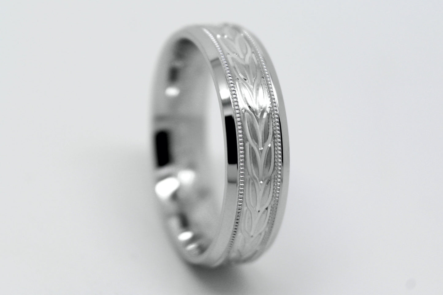 white gold beveled wedding band for men with beveled and floral brushed design