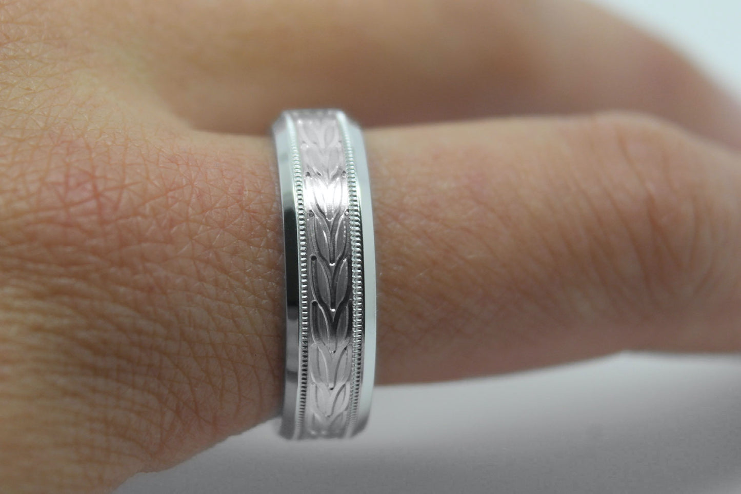 white gold beveled wedding band for men with beveled and floral brushed design