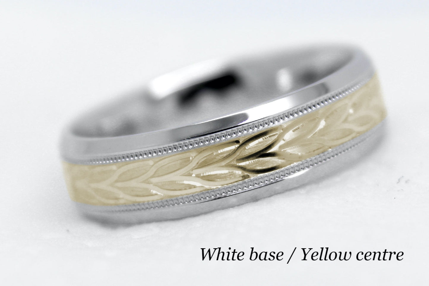 beveled wedding band for men with white gold beveled base and yellow gold floral brushed design