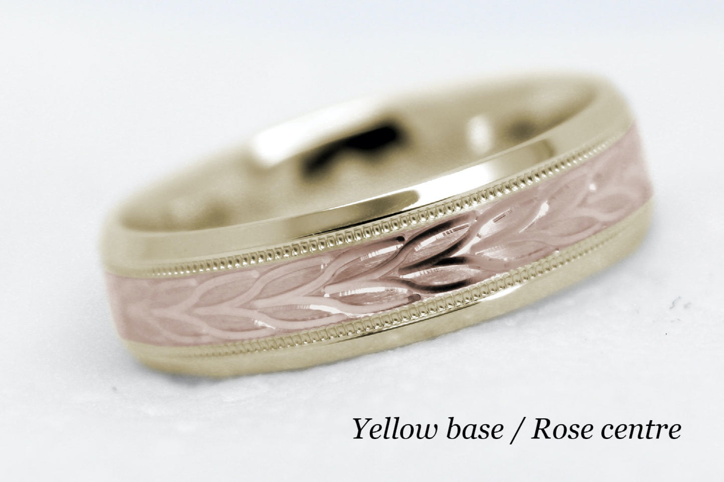 beveled wedding band for men with yellow gold beveled base and rose gold floral brushed design