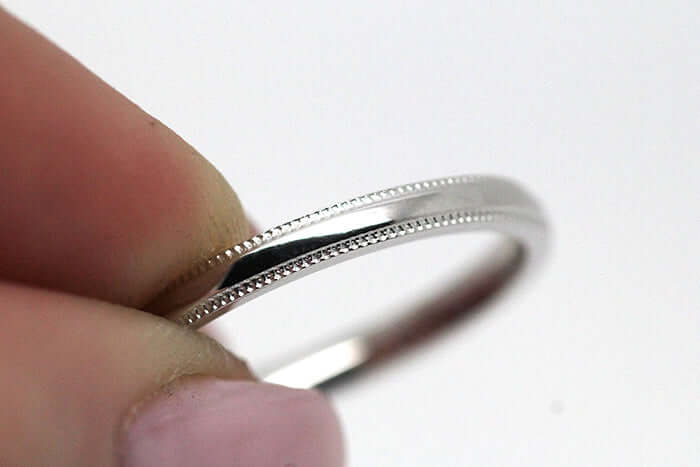 classic owlish ring is held with finger