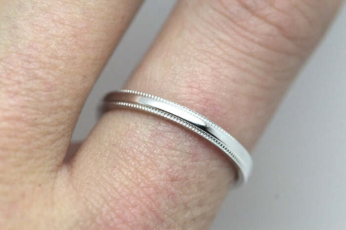 simple ring with milgrain is on the finger