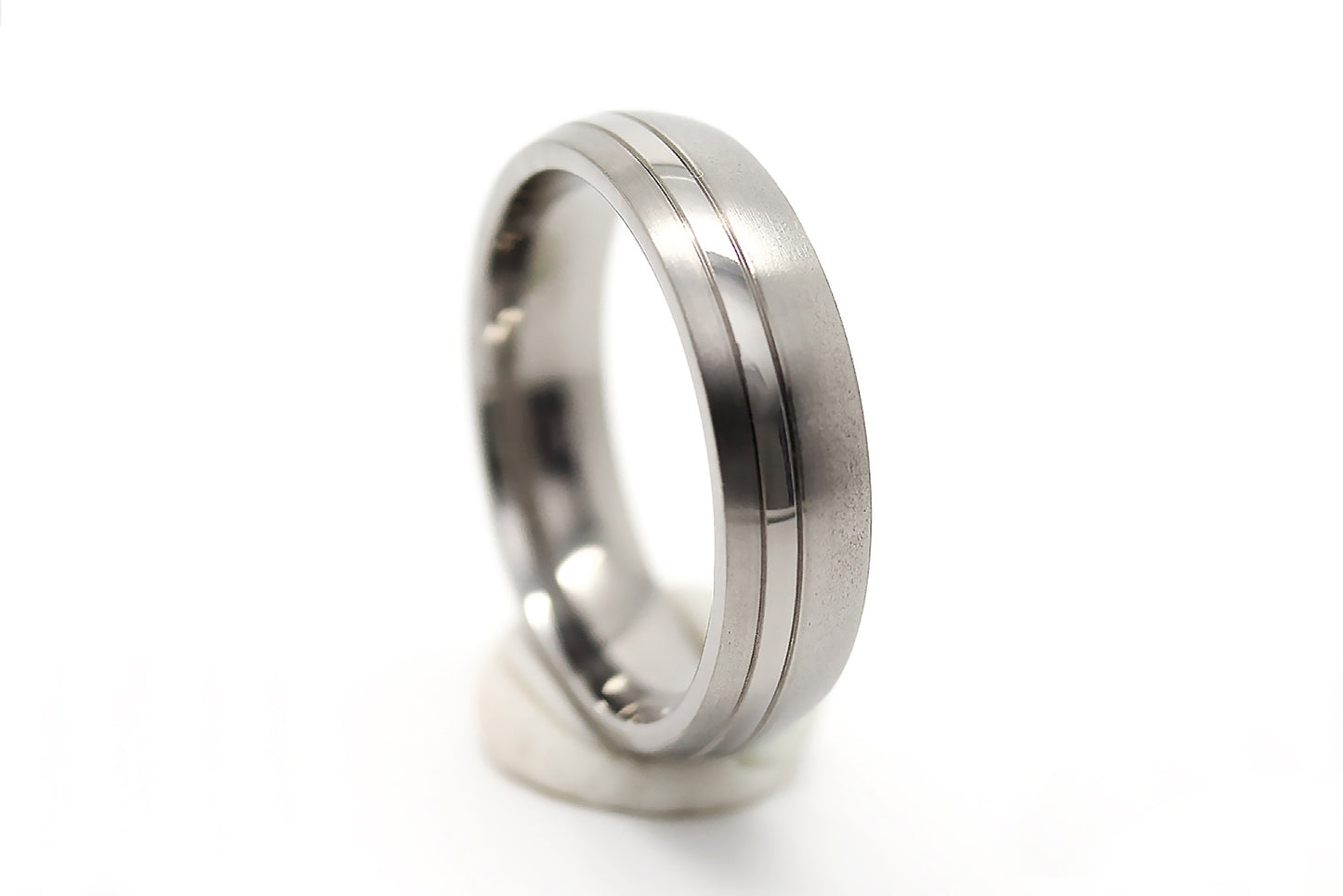 Titanium ring with a grooved design on a white background