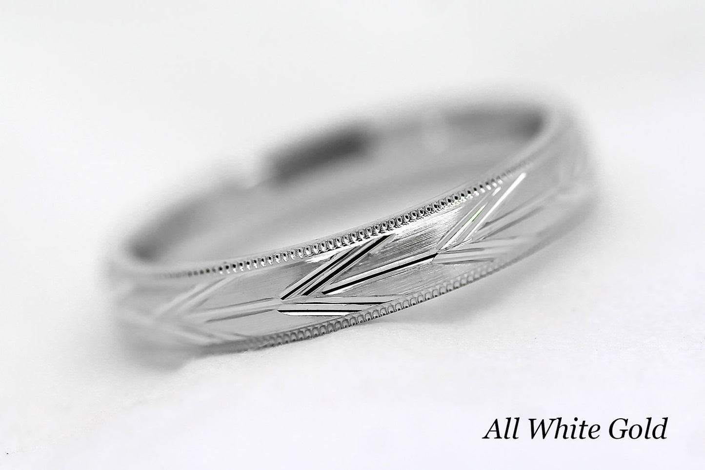 4mm solid gold wedding band in white gold, featuring brushed centre with incut arrows design and milgrain edge, available in 10k gold 14k gold or 18k gold