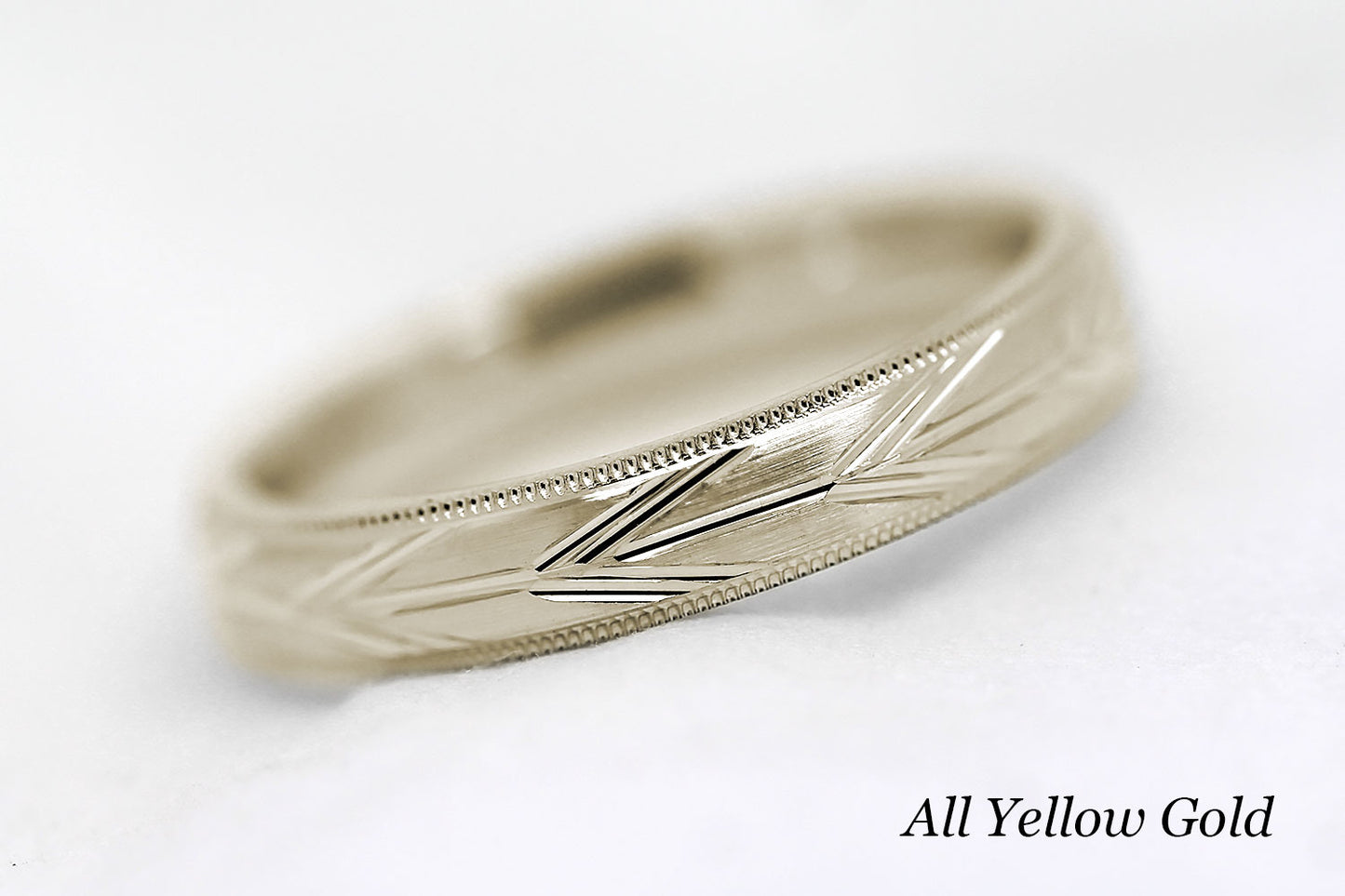 4mm solid gold wedding band in yellow gold, featuring brushed centre with incut arrows design and milgrain edge, available in 10k gold 14k gold or 18k gold
