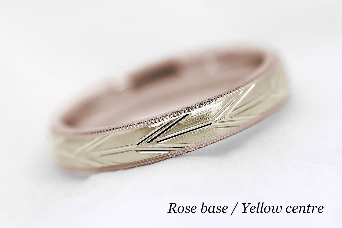 4mm solid gold wedding band with rose gold base and yellow gold centre, featuring brushed centre with incut arrows design and milgrain edge, available in 10k gold 14k gold or 18k gold