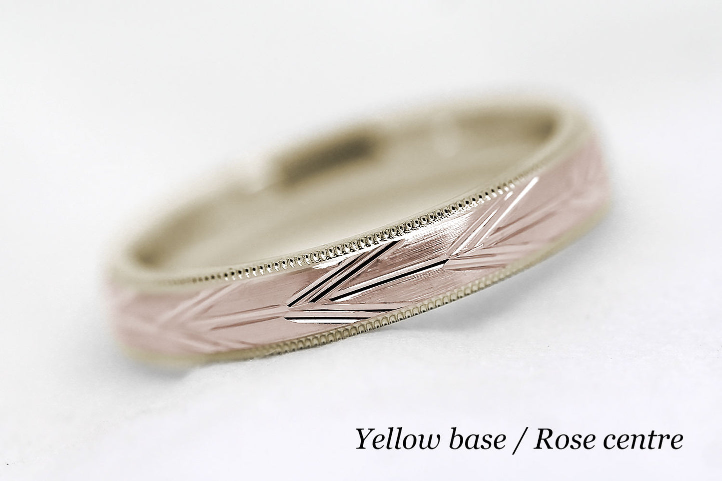 4mm solid gold wedding band with yellow gold base and rose gold centre, featuring brushed centre with incut arrows design and milgrain edge, available in 10k gold 14k gold or 18k gold