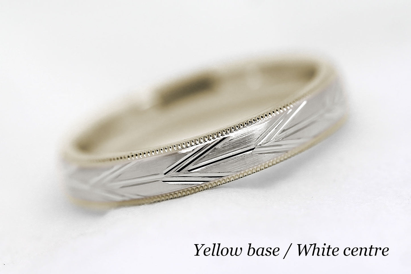 4mm solid gold wedding band with yellow gold base and white gold centre, featuring brushed centre with incut arrows design and milgrain edge, available in 10k gold 14k gold or 18k gold