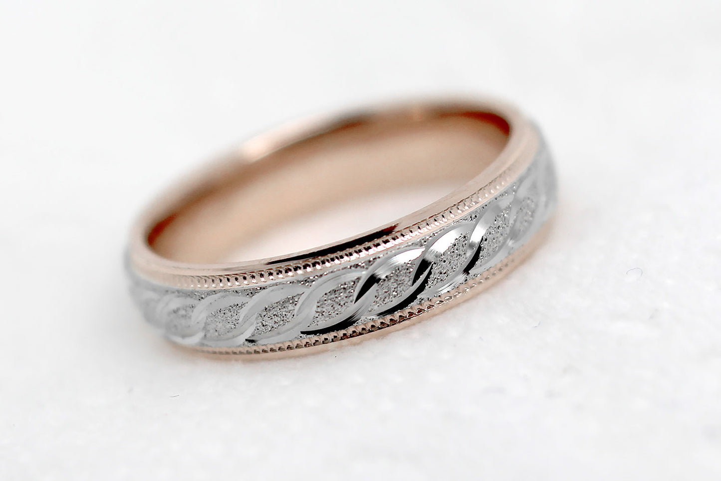 4mm solid gold wedding band with rose gold base and white gold, featuring stone finish centre with incut moons design and milgrain edge, available in 10k gold 14k gold and 18k gold