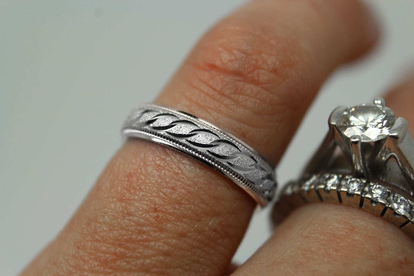4mm solid 925 sterling silver wedding band in white gold, featuring stone finish centre with incut moons design and milgrain edge