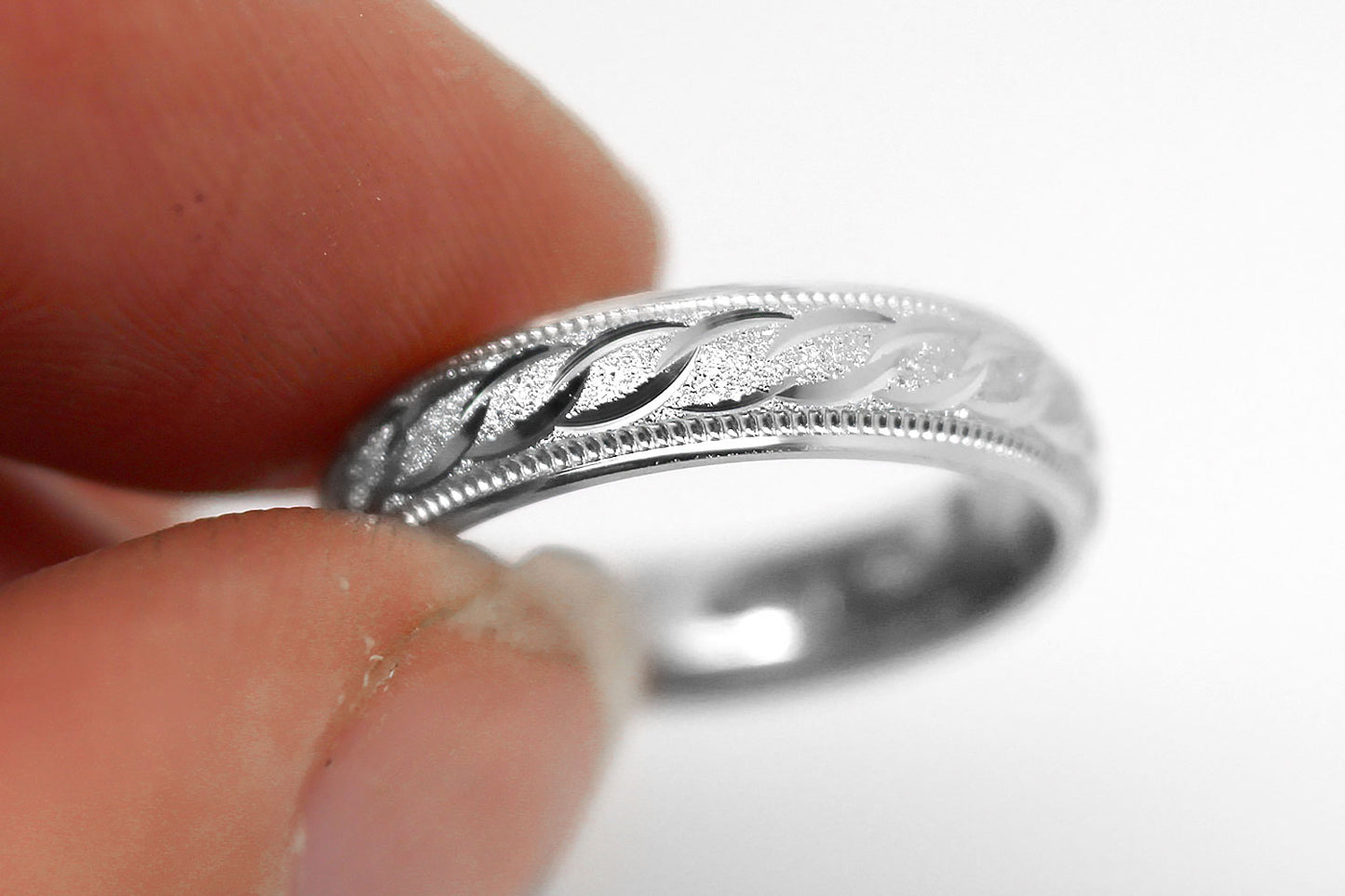 4mm solid 925 sterling silver wedding band in white gold, featuring stone finish centre with incut moons design and milgrain edge