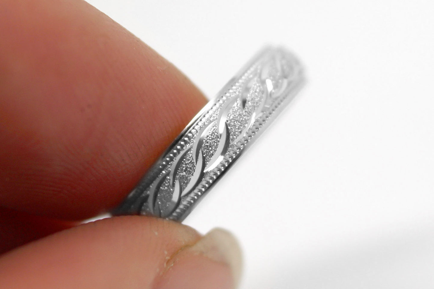 4mm solid 925 sterling silver wedding band in white gold, featuring stone finish centre with incut moons design and milgrain edge