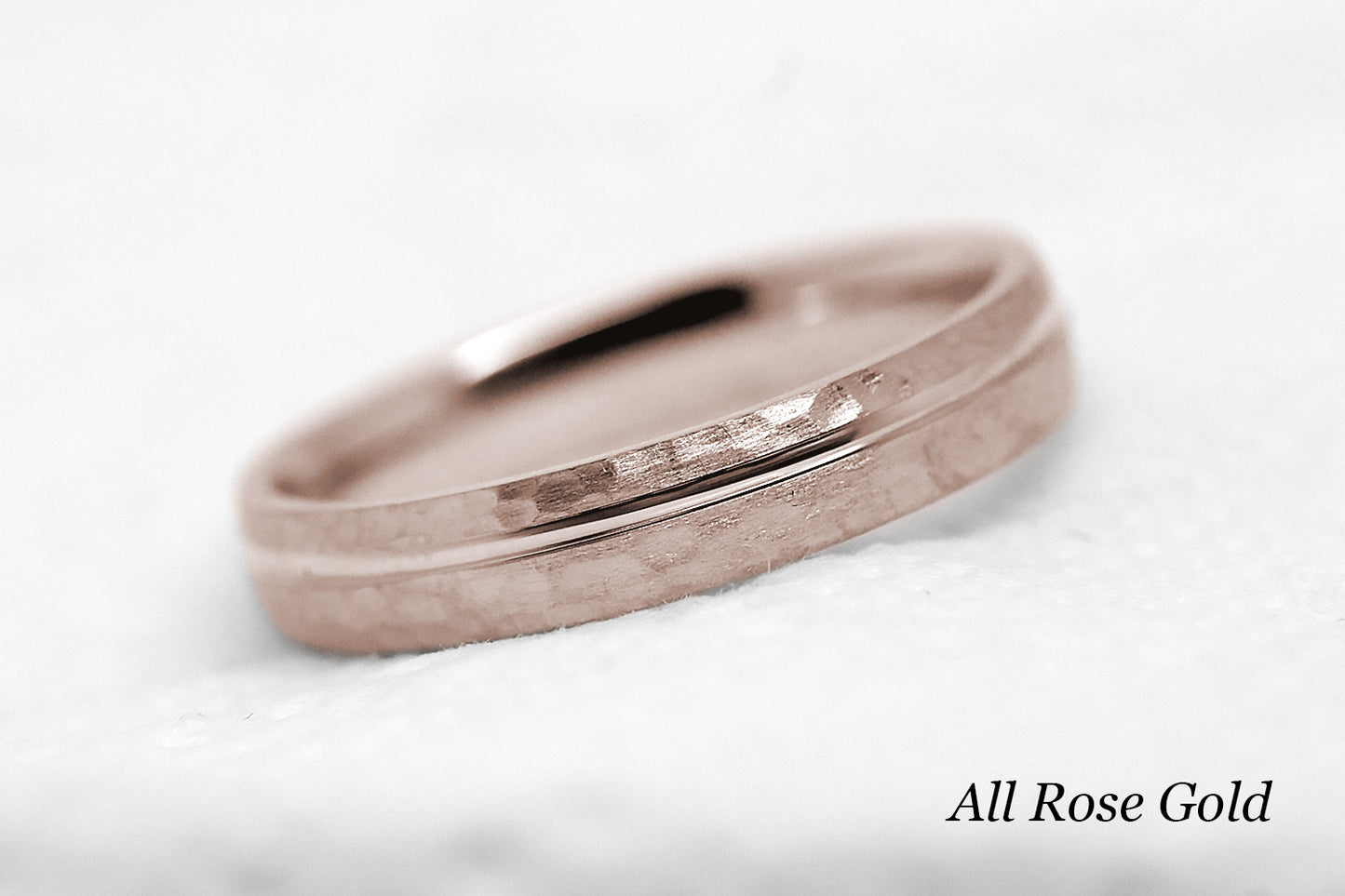 4mm 10 karat 14 karat or 18 karat solid gold hammered wedding band in rose gold with off centre rose gold polished line