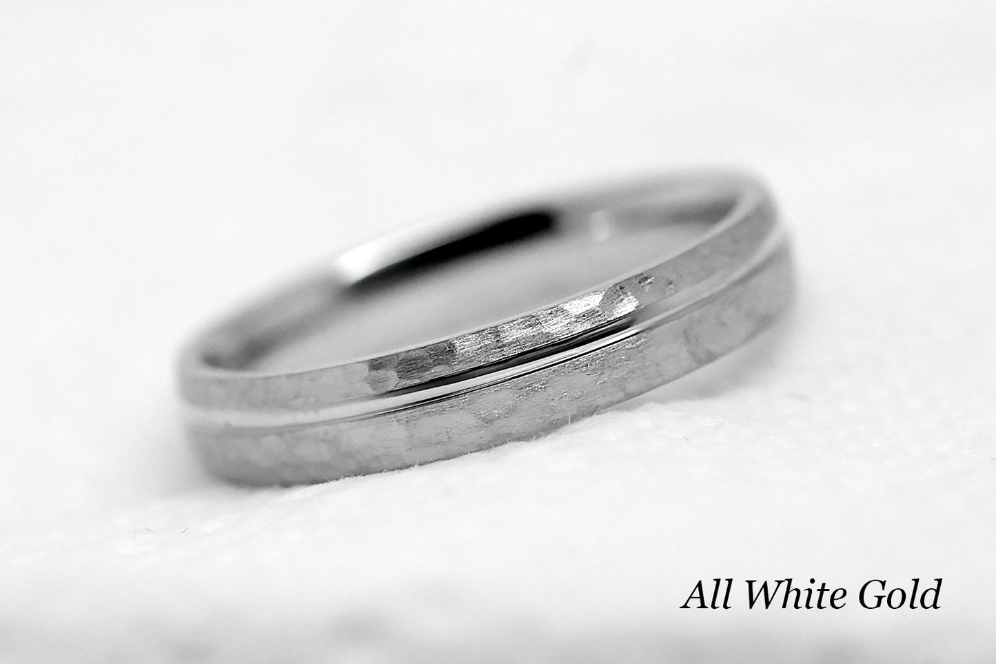 4mm 10 karat 14 karat or 18 karat solid gold hammered wedding band in white gold with off centre white gold polished line