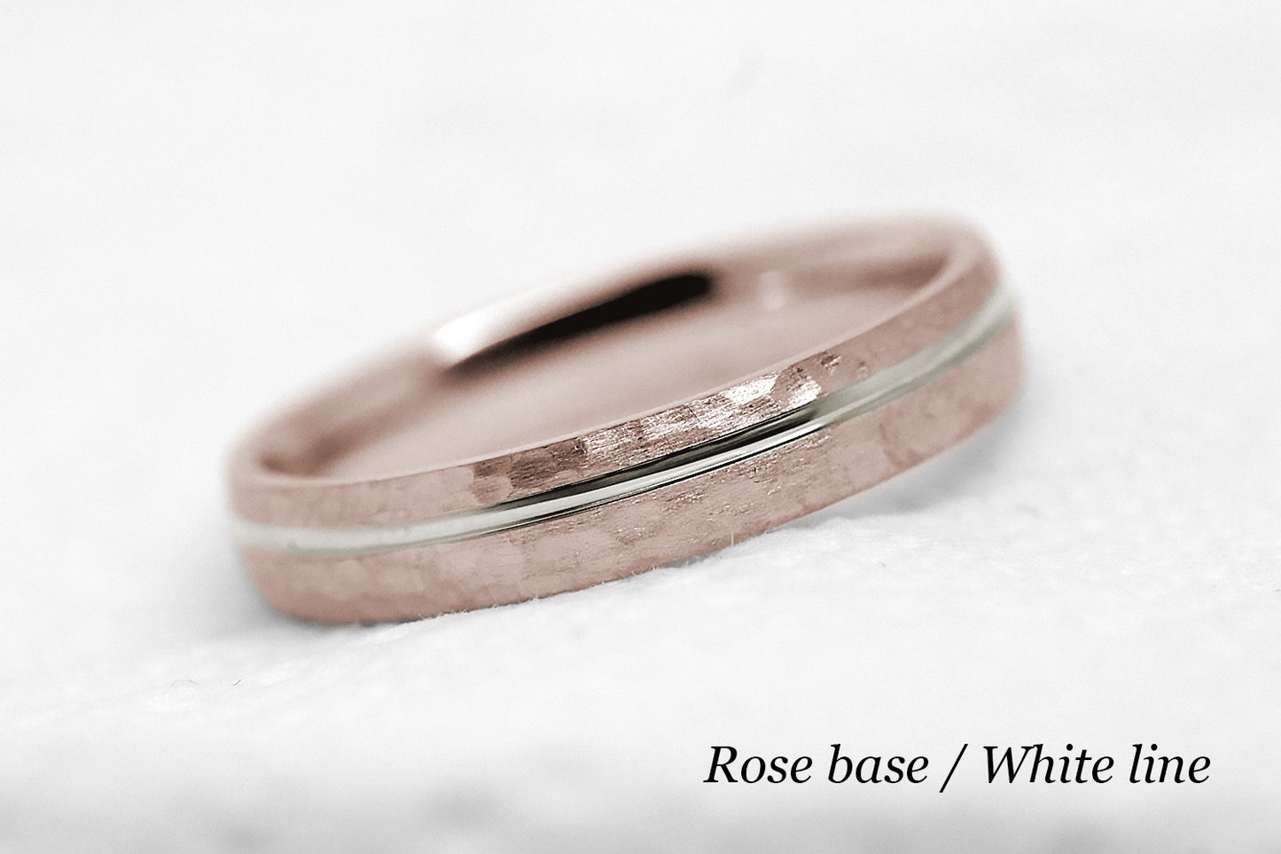 4mm 10 karat 14 karat or 18 karat solid gold hammered wedding band in rose gold with off centre white gold polished line
