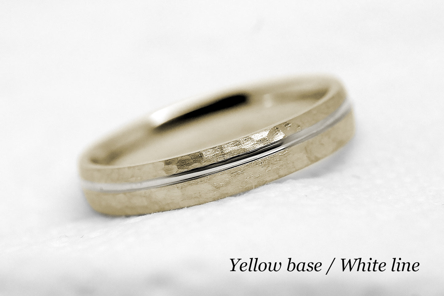 4mm 10 karat 14 karat or 18 karat solid gold hammered wedding band in yellow gold with off centre white gold polished line