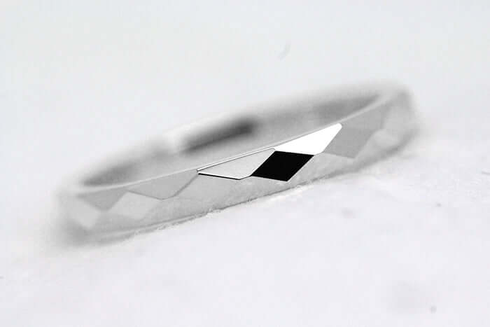 2mm sterling silver wedding band laying on its side