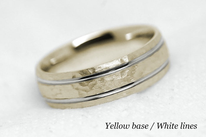 Solid gold hammered wedding ring for men and women with polished lines. Handcrafted in yellow gold base and white gold lines