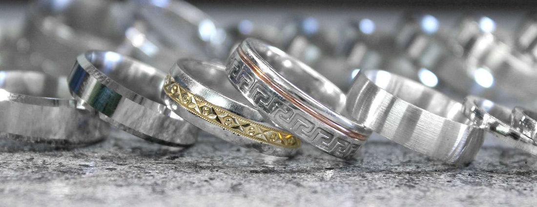 multiple white gold and silver wedding rings displayed to be polished