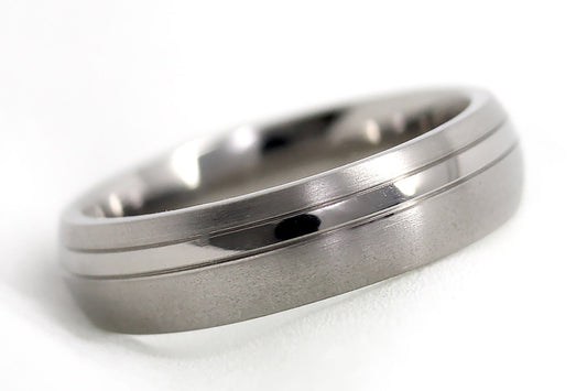 Titanium ring with a brushed finish on a white background
