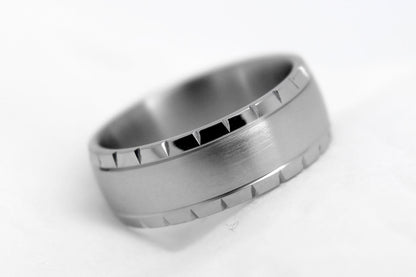 Matte Titanium ring with a textured band on a white background