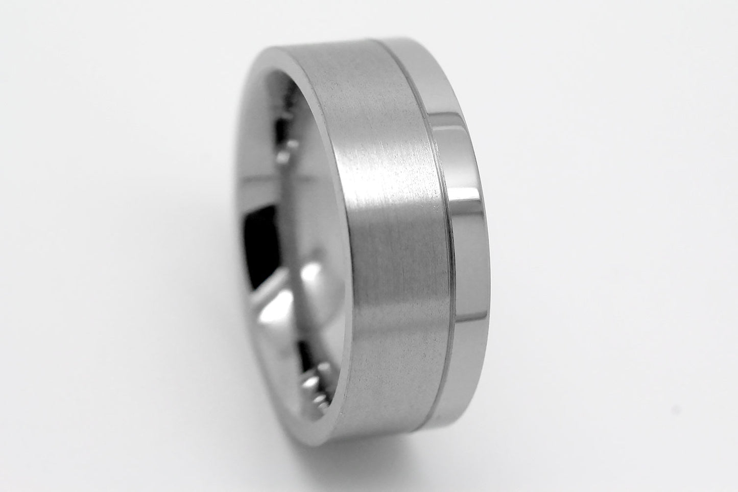 Flat Titanium ring on a light gray background