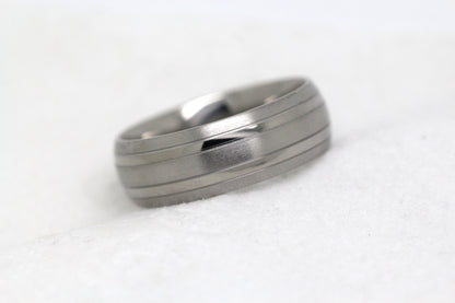 Matte 8mm titanium wedding ring for men and women with polished lines, perfect for anniversaries and engagements.