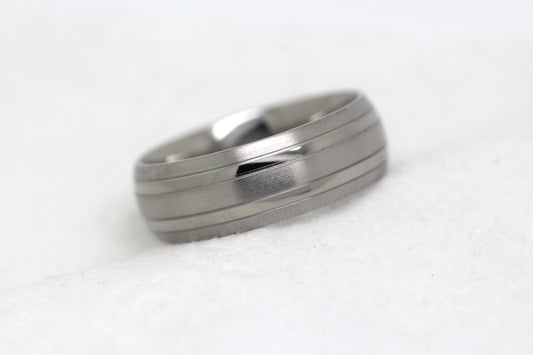 Matte 8mm titanium wedding ring for men and women with polished lines, perfect for anniversaries and engagements.