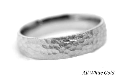 White gold ring with a hammered surface on a white background.