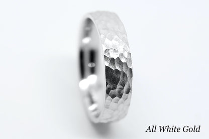 White gold ring with hammered design on a white background