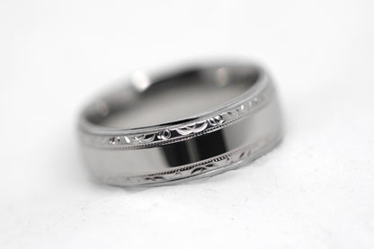 Polished 6mm titanium wedding ring for men and women with filigree edge, perfect for anniversaries and engagements.