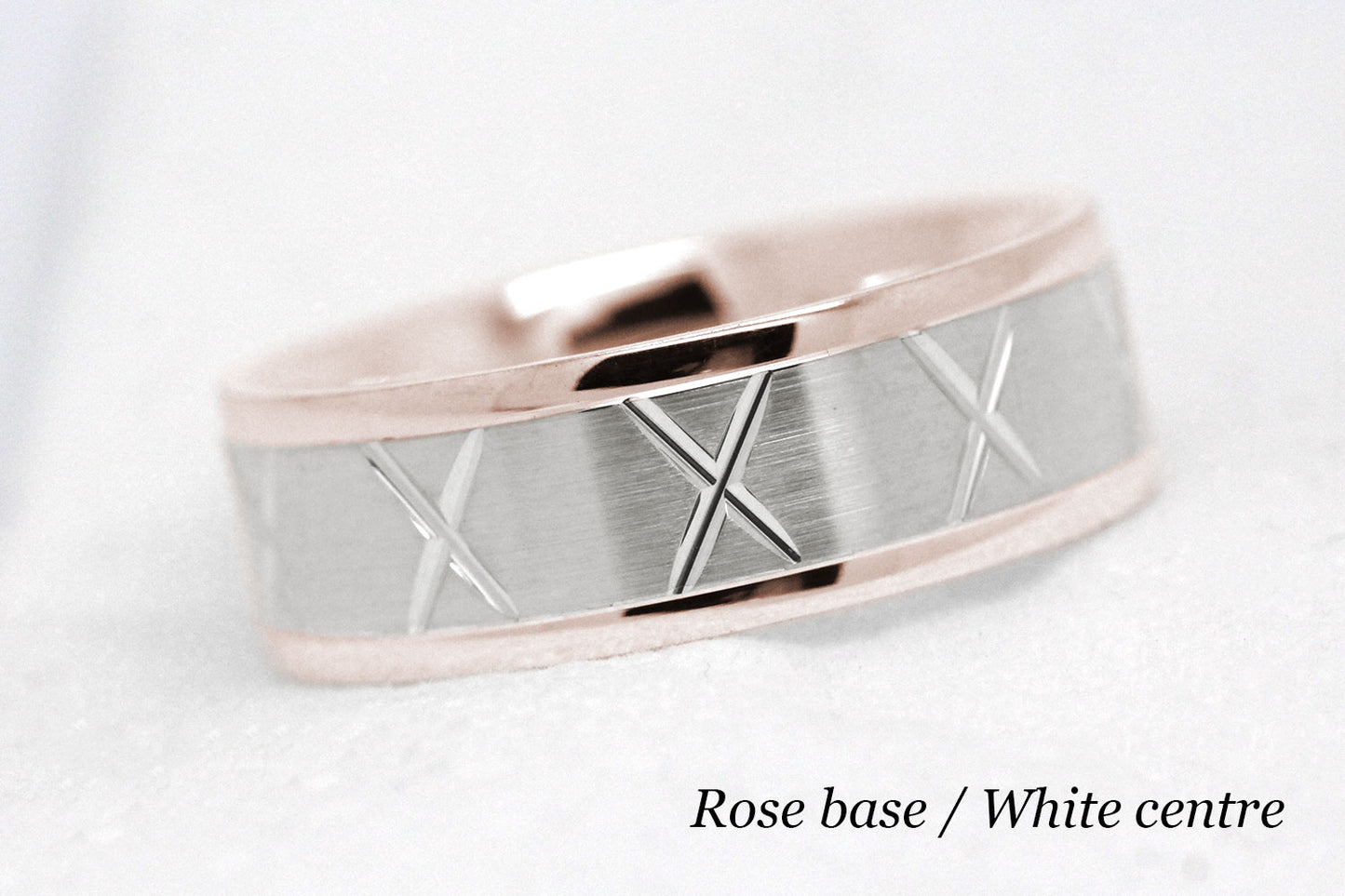gold wedding band for men in brushed finish centre. X design around the entire ring . rose Gold base and white gold centre