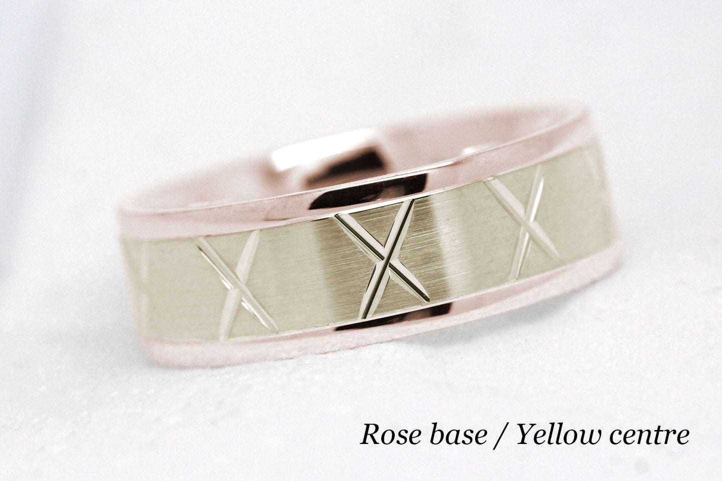 gold wedding band for men in brushed finish centre. X design around the entire ring . Rose Gold base and yellow gold centre