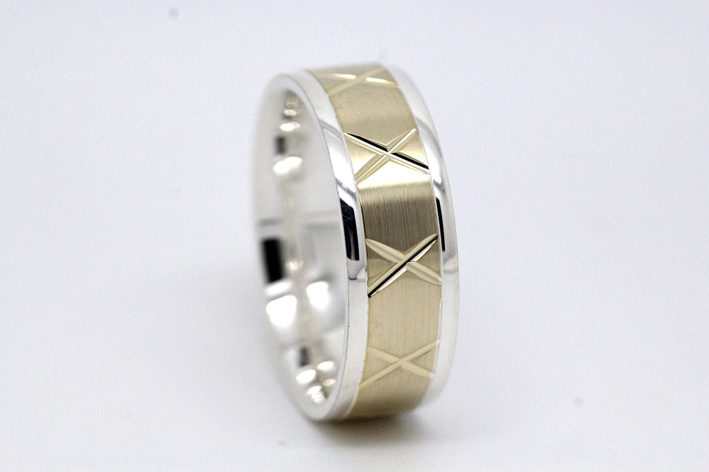 gold wedding band for men in brushed finish centre. X design around the entire ring . White Gold base and yellow gold centre