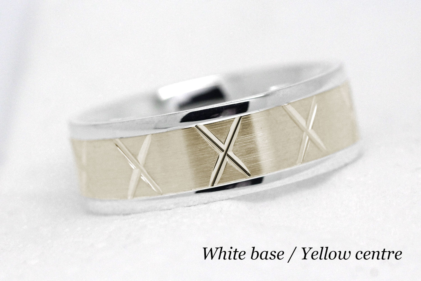 gold wedding band for men in brushed finish centre. X design around the entire ring . White Gold base and yellow gold centre
