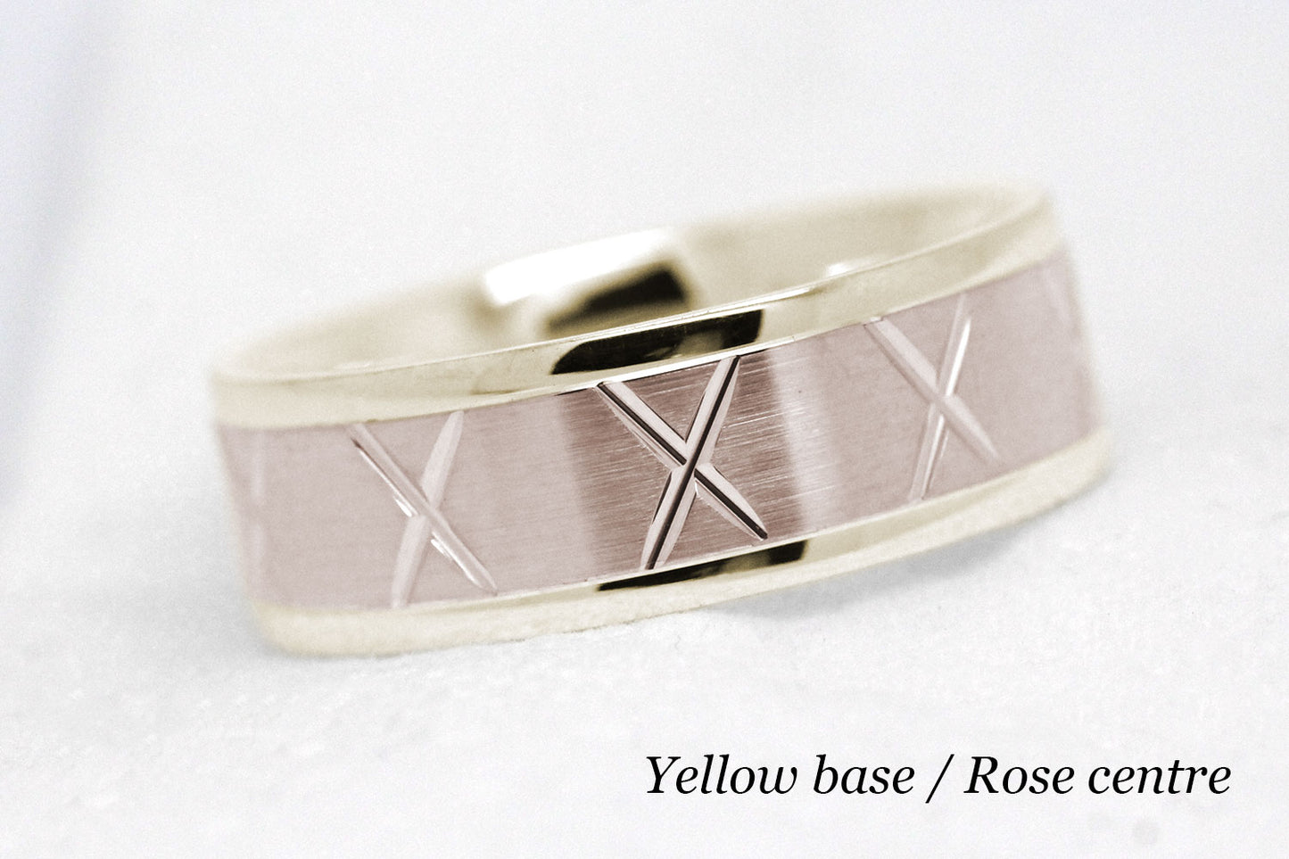 gold wedding band for men in brushed finish centre. X design around the entire ring . Yellow Gold base and rose gold centre