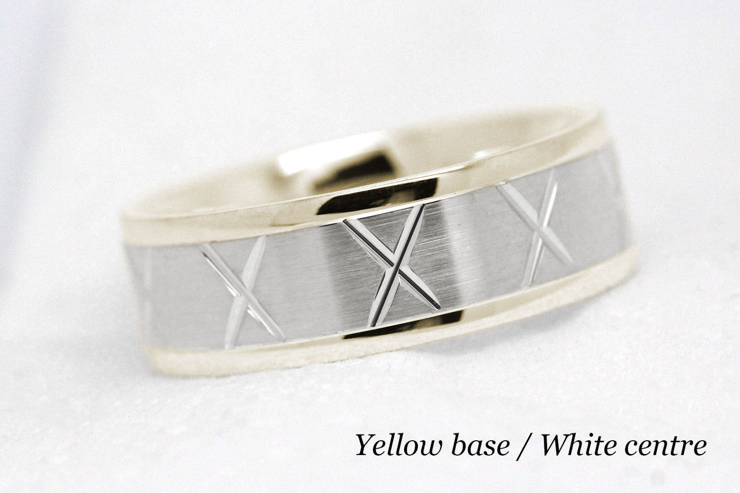 gold wedding band for men in brushed finish centre. X design around the entire ring . Yellow Gold base and White gold centre