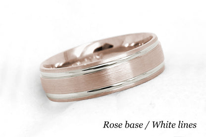 solid gold wedding band for men and women in rose gold base and white gold lines. Brushed finish with polished lines.