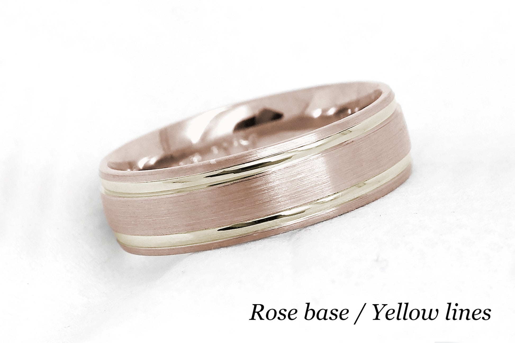 solid gold wedding band for men and women in rose gold base and yellow gold lines. Brushed finish with polished lines.