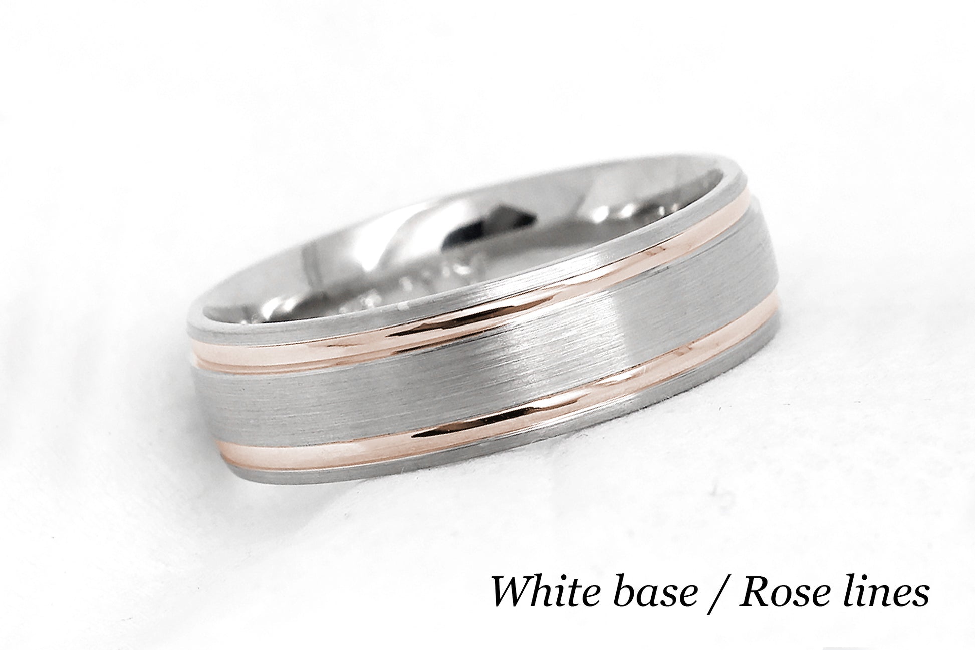 solid gold wedding band for men and women in white gold base and rose gold lines. Brushed finish with polished lines.