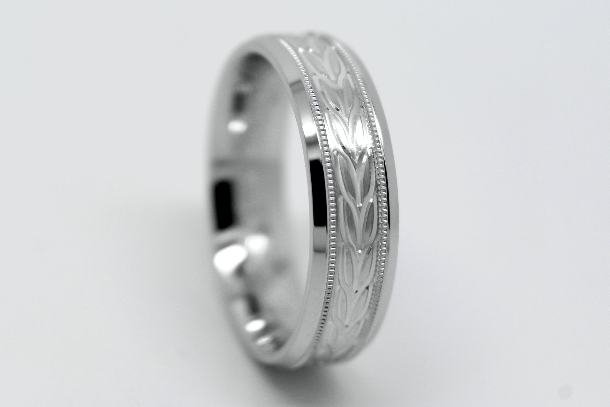 white gold beveled wedding band for men with beveled and  floral brushed design