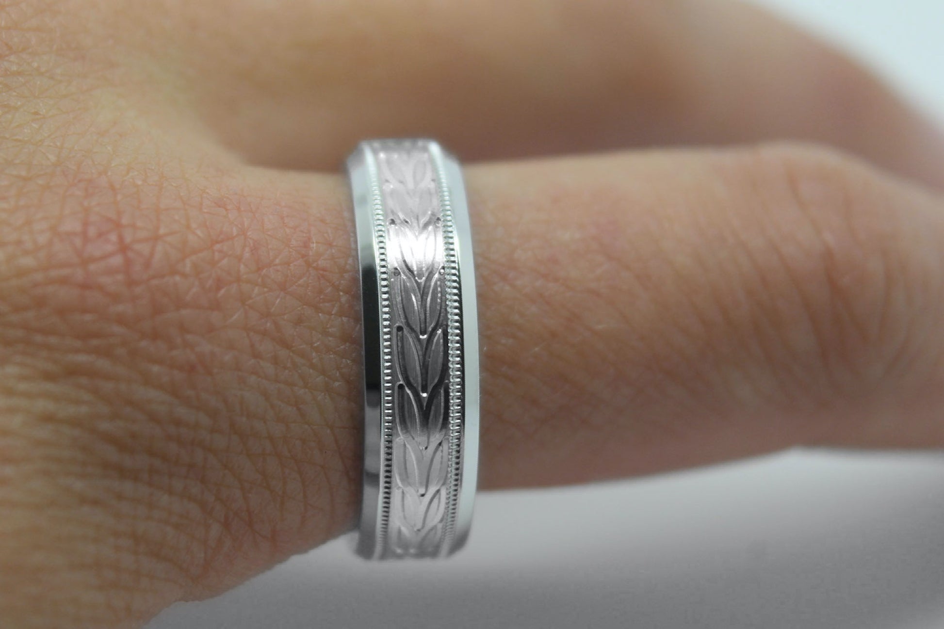 white gold beveled wedding band for men with beveled and  floral brushed design