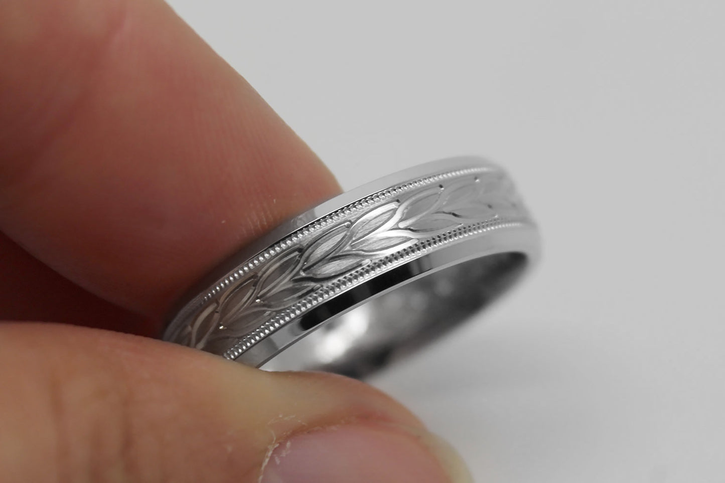 white gold beveled wedding band for men with beveled and  floral brushed design
