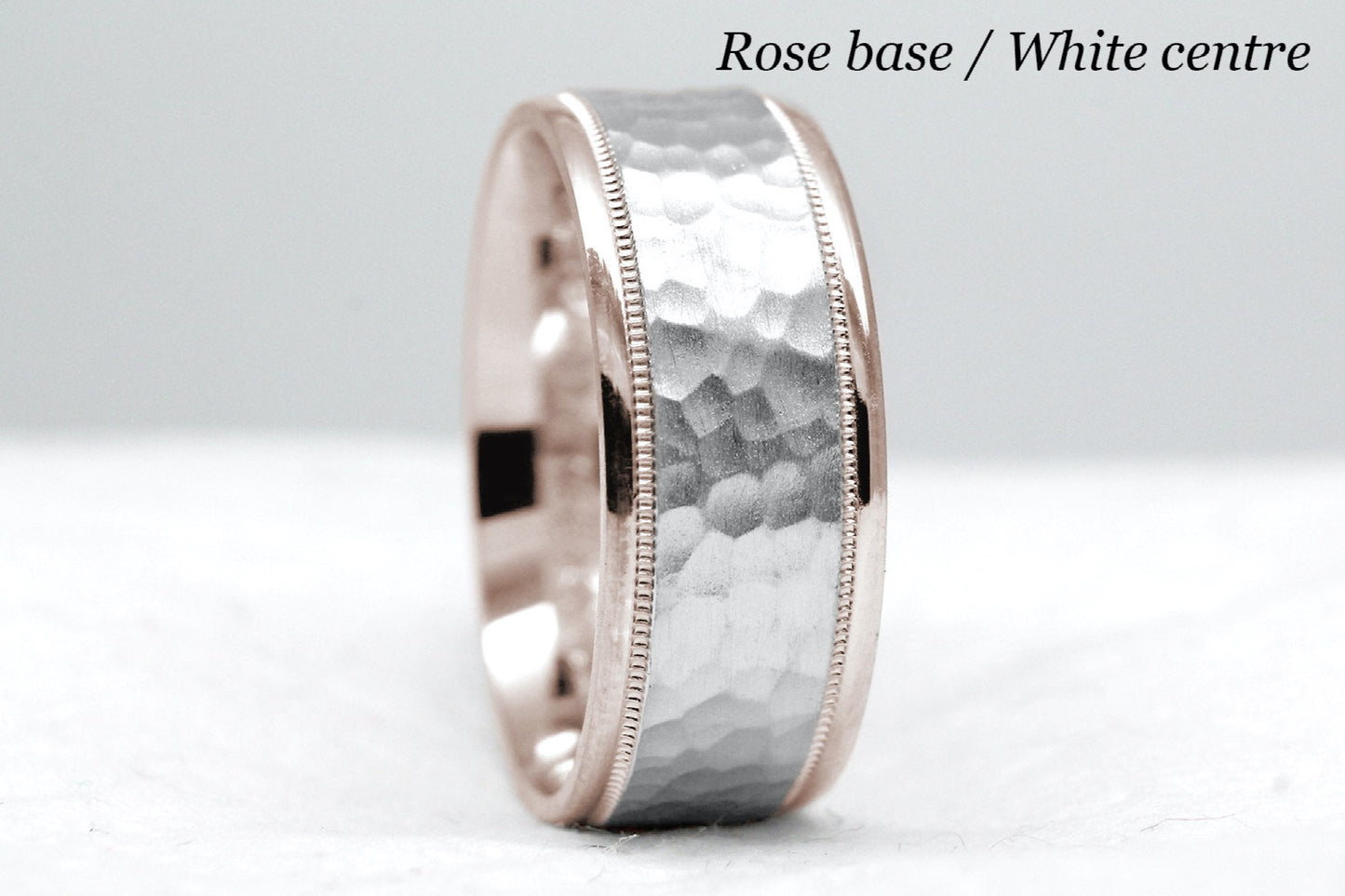 rose gold base and white gold centre. 8mm hammered wedding band for men and women